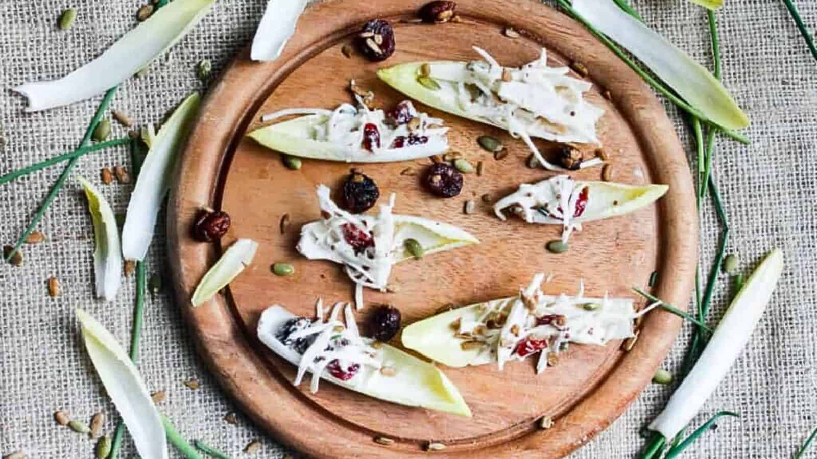 Holiday apple and cranberry appetizers on a wooden platter.