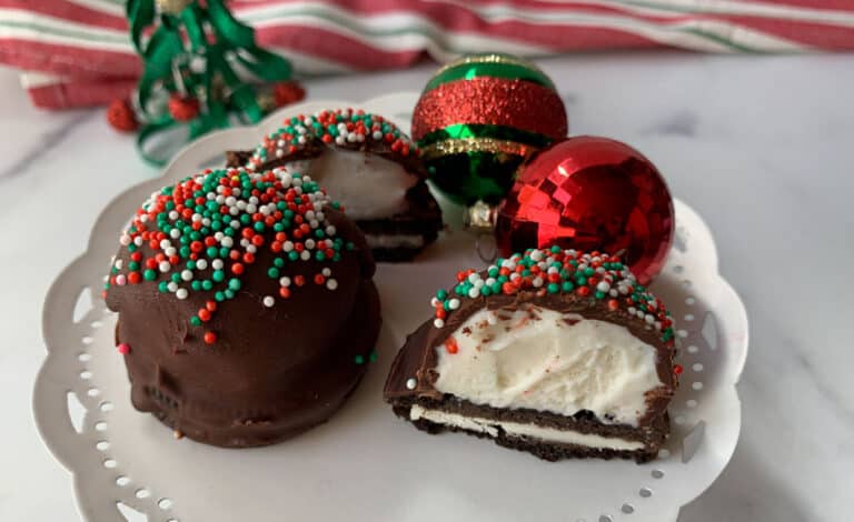 Oreo cookies with chocolate ice cream and sprinkles on a plate.