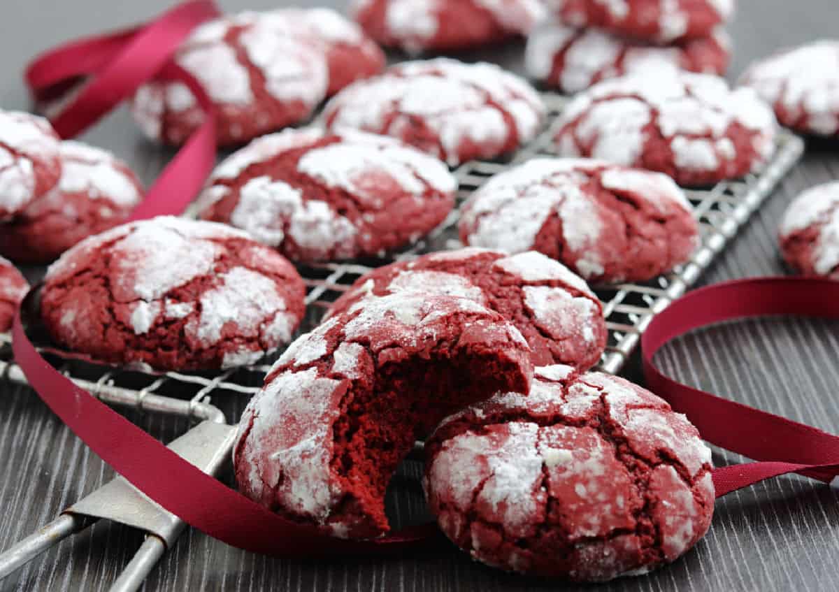 A cooling rack with red velvet crinkle cookies.