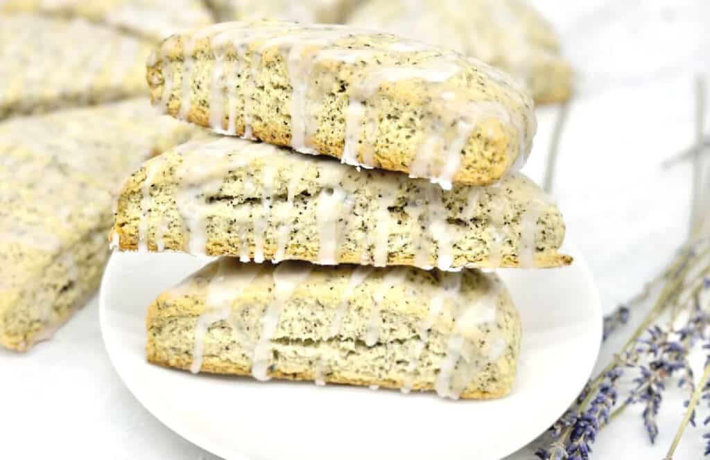 A stack of scones with icing and lavender.