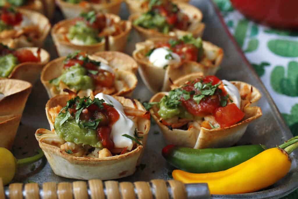 Mexican tortilla cups with guacamole and sour cream.