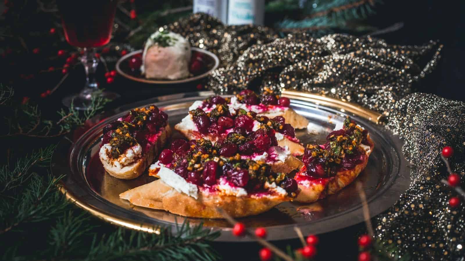 Cranberry and pistachio crostini on a plate.