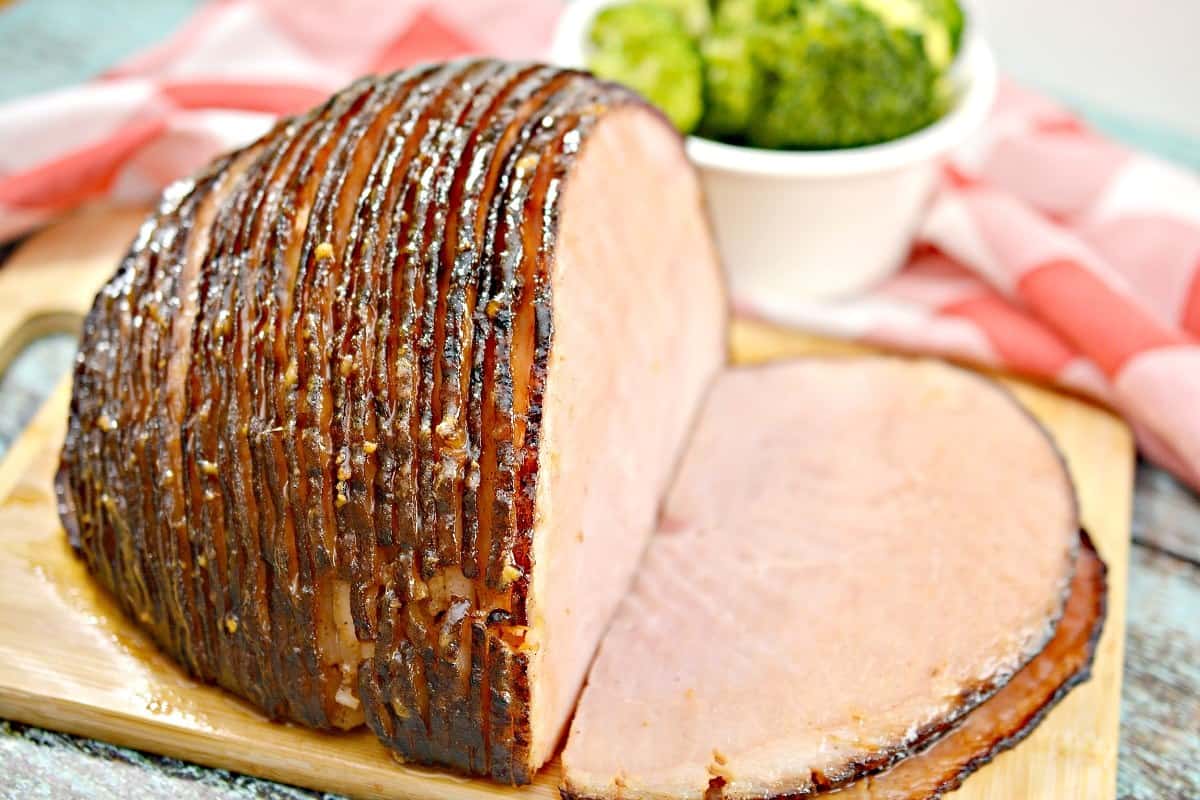 A piece of ham on a cutting board.