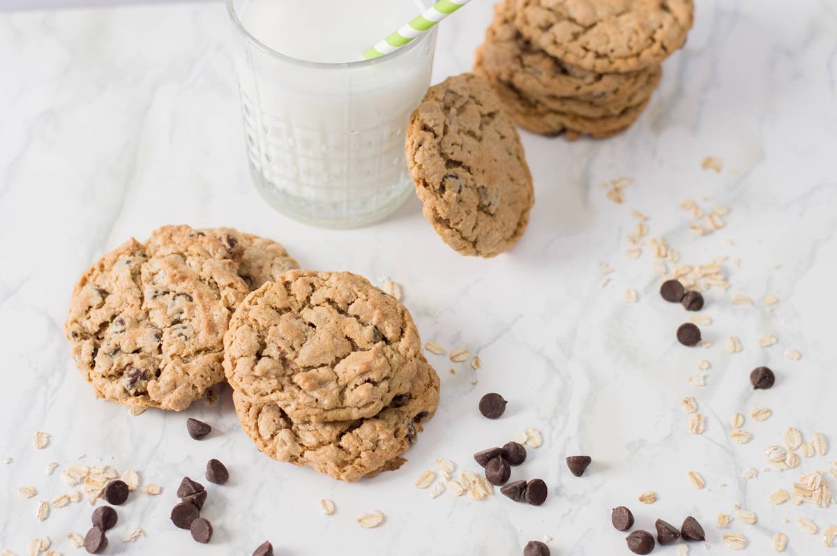 A glass of milk and cookies on a marble table.