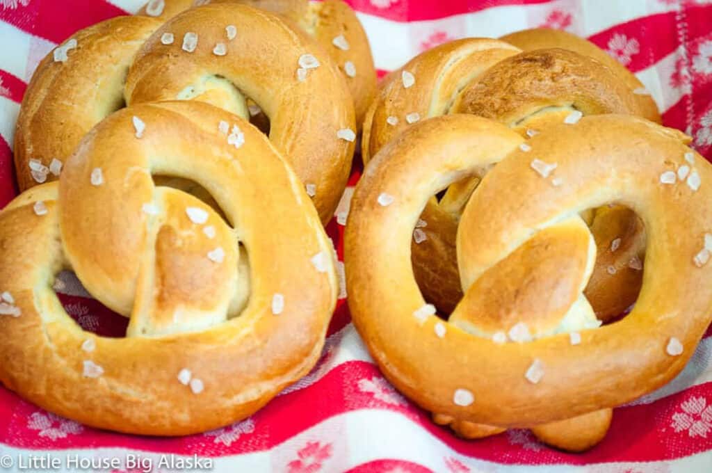 Pretzels in a red and white checkered bread basket.