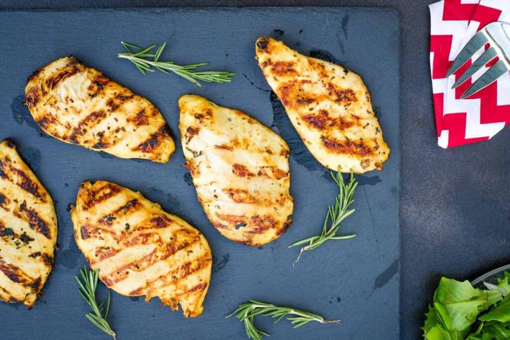 Easy chicken recipes: Grilled chicken breasts on a slate board.