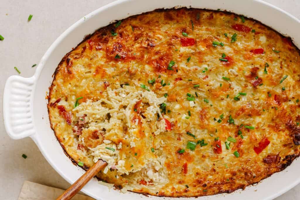 A casserole dish with a spoon in it.