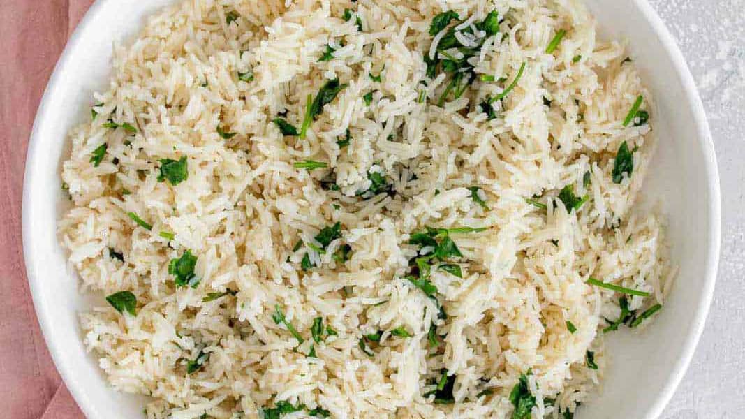 Top and closeup view of a bowl of rice garnished with cilantro