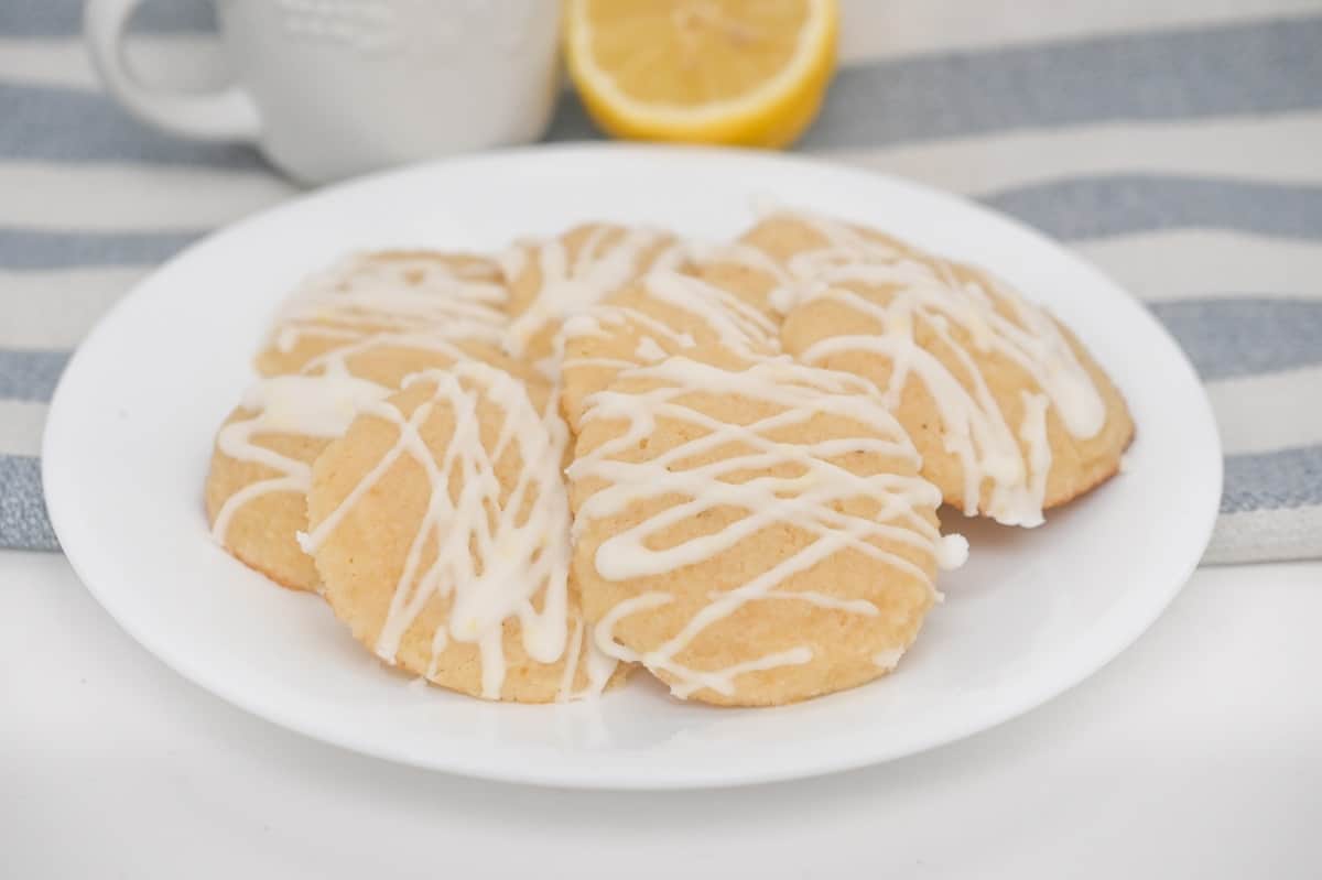 Lemon cookies with icing on a plate.