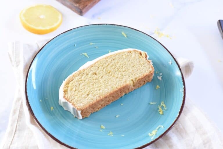A slice of lemon pound cake on a blue plate.