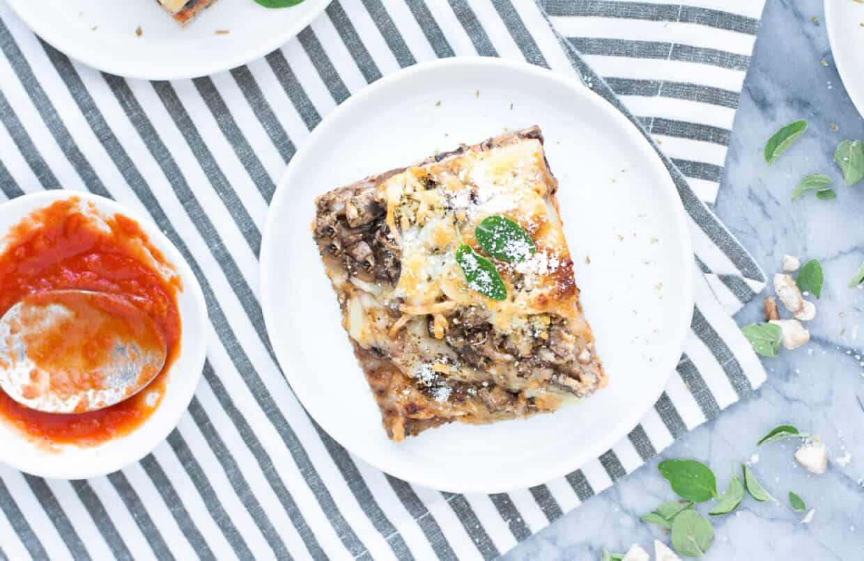 A pizza with meat and sauce on a plate.