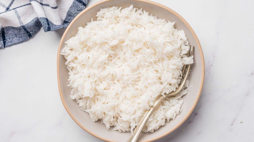 White rice in a bowl on a marble table.