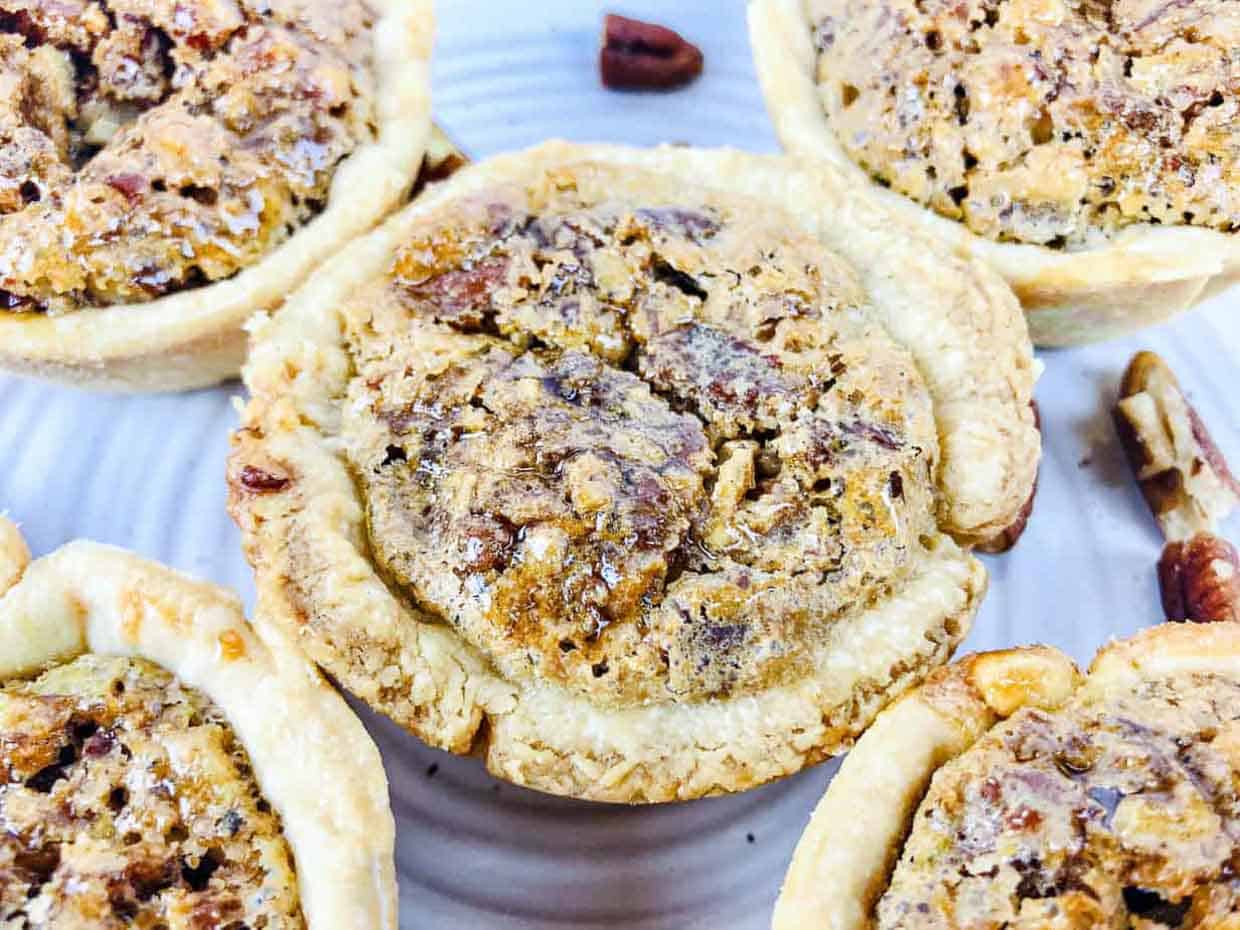 Mini pecan pies in a crispy baked crust.