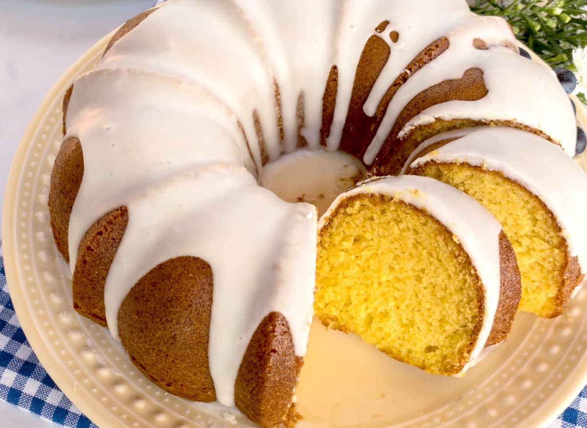 An overhead view of an iced Mountain Dew bundt cake on a yellow plate.