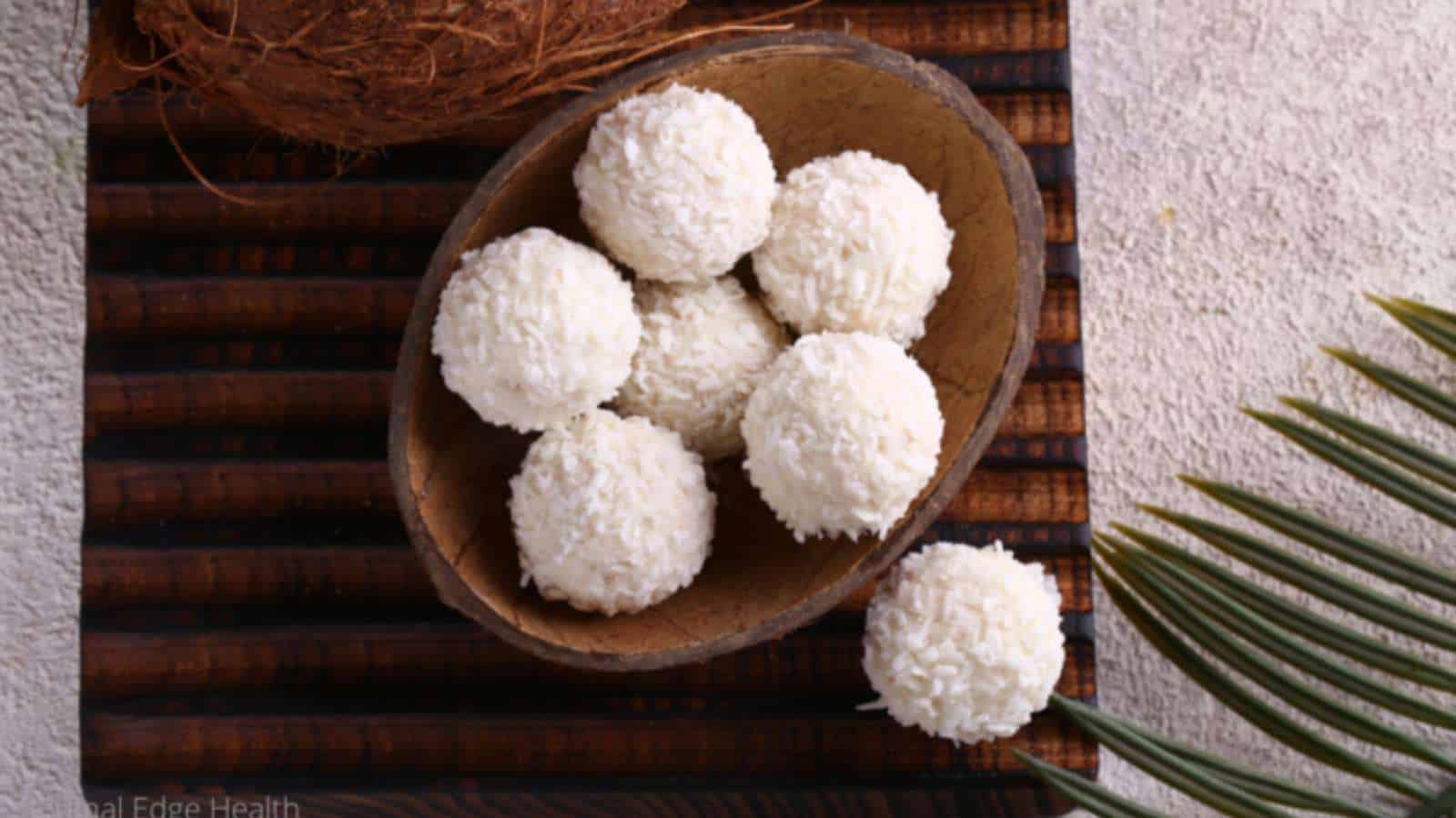 No-bake coconut macaroons in coconut shell on stripped cloth.