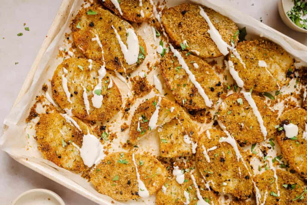 A baking sheet filled with parmesan crusted potatoes.