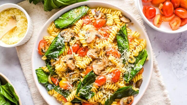 Pasta with mushrooms, cherry tomatoes and basil.