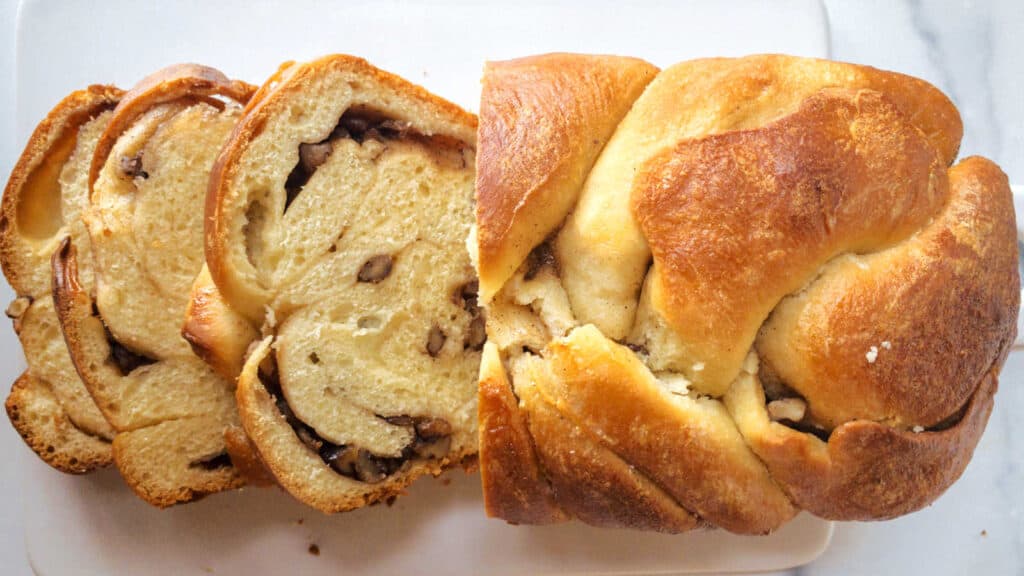 A sliced loaf of yeast bread with pecans.
