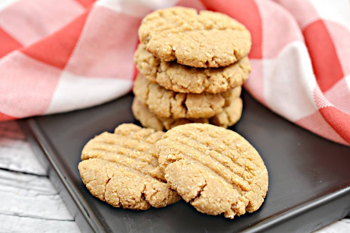 Peanut butter cookies on a black plate.