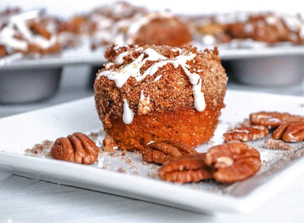 Pecan muffin on a white plate.