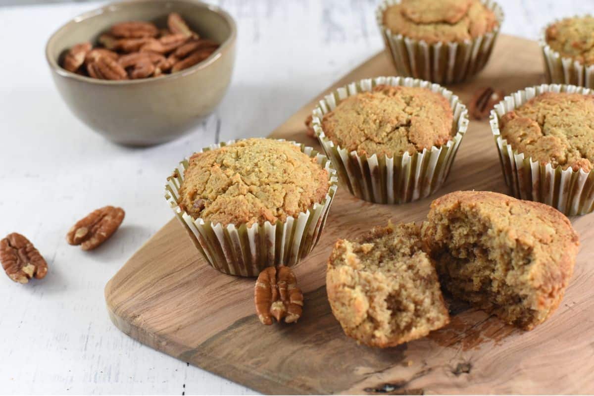 Pecan muffins on a cutting board.