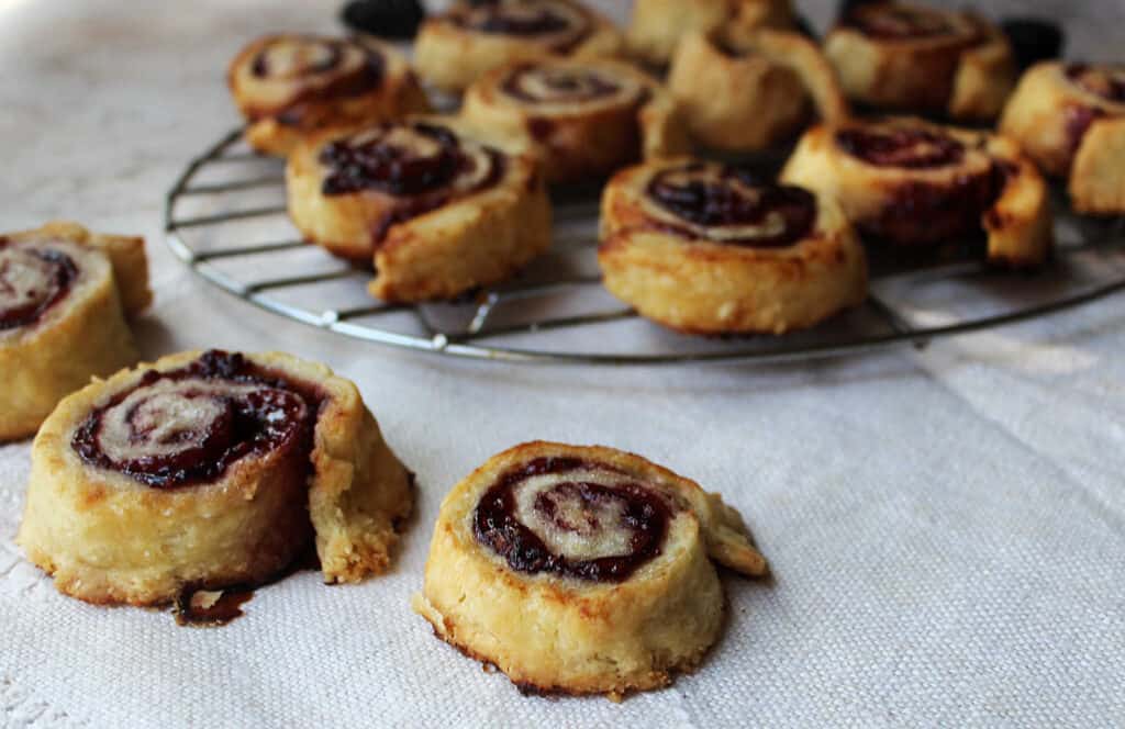 A group of pastries on a cooling rack.