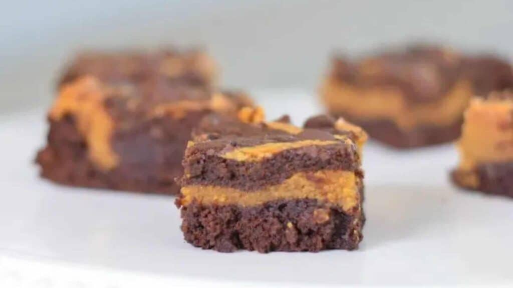 Peanut butter brownies on a white plate.