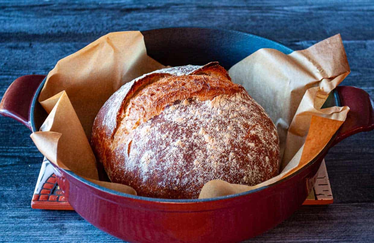 A loaf of Quick Dutch Oven Bread in a braiser.