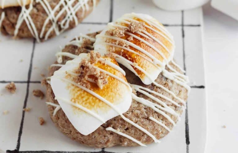 A cookie with marshmallows and icing on top.