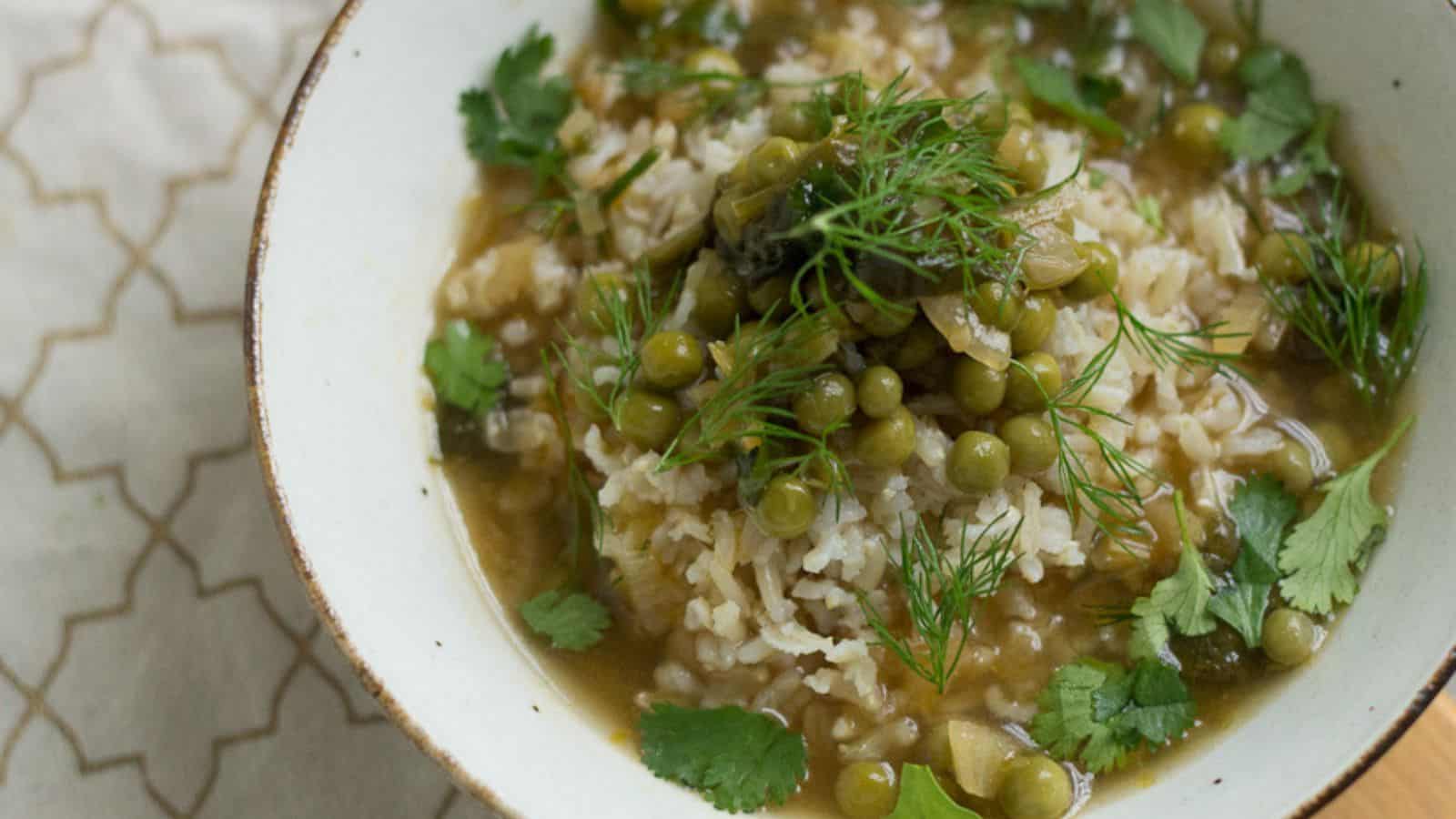 A bowl of rice and peas, a delectable veggie main, on a rustic wooden table.