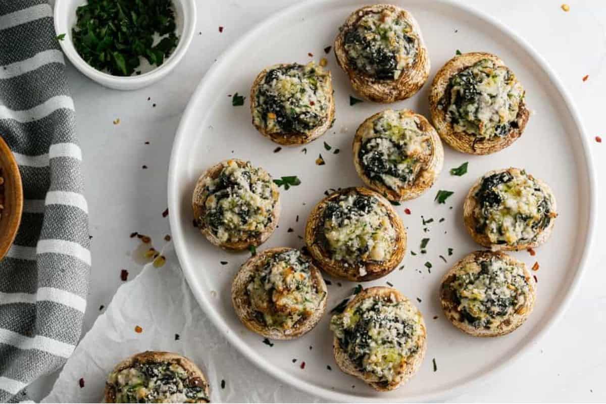 Stuffed mushrooms on paper and plate.