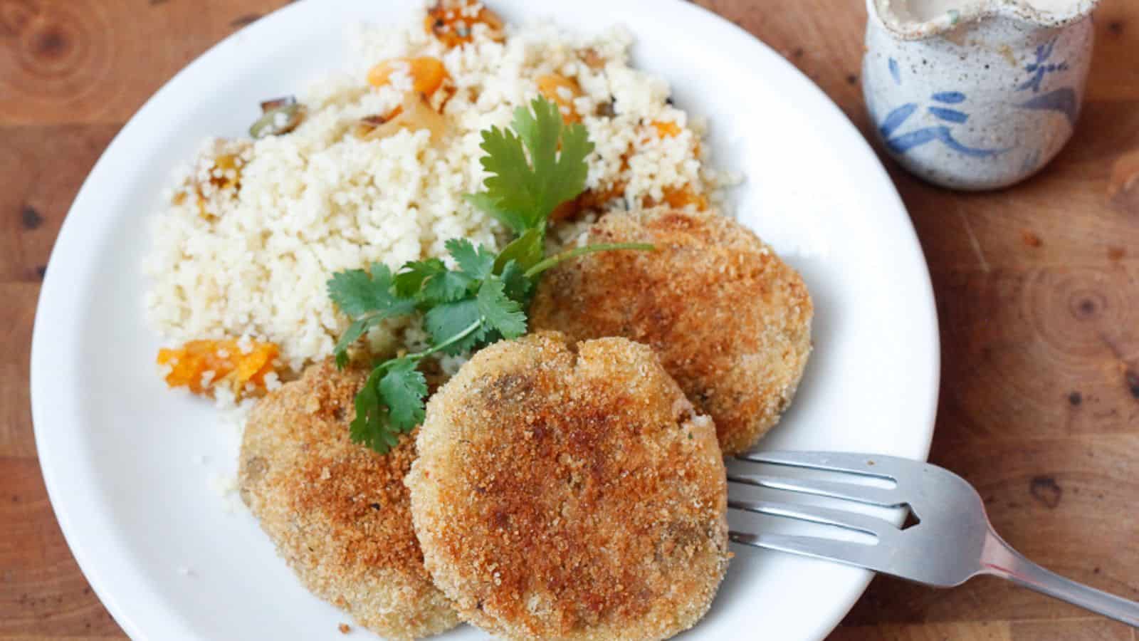 Three patties on a plate with rice.