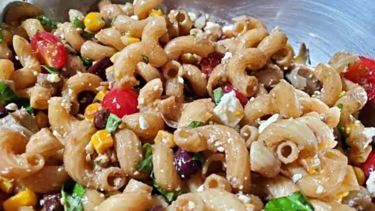 Image shows a closeup of a Summer Pasta Salad with Mediterranean flavors.