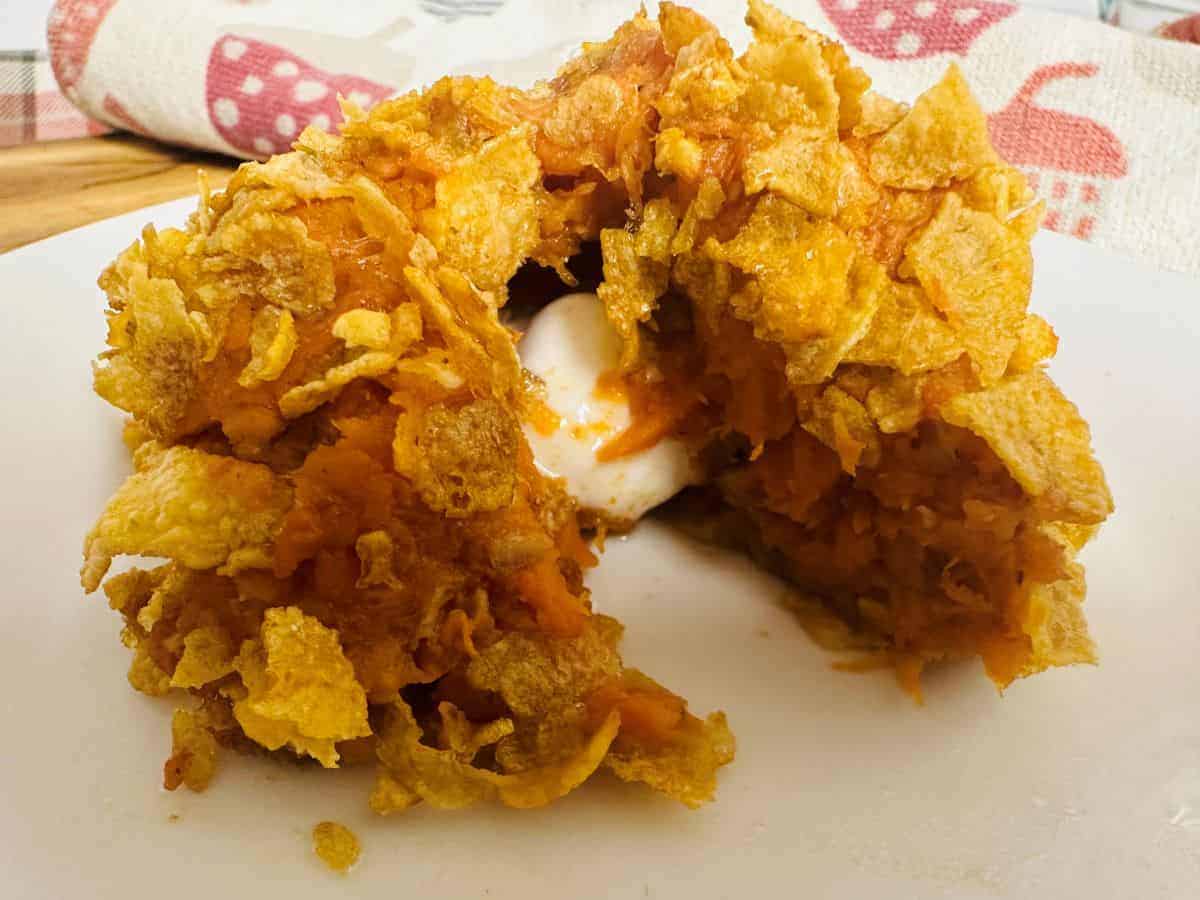 A plate with a bite out of a sweet potato puff.