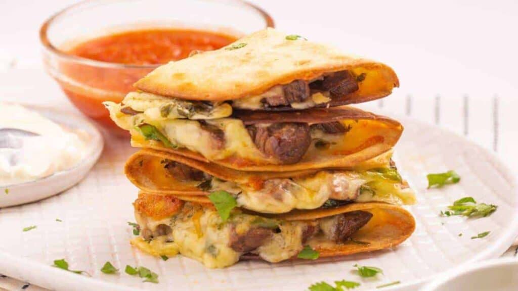 A stack of quesadillas on a plate.