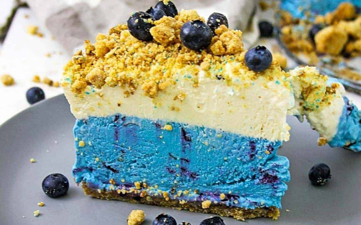 A slice of blueberry cheesecake on a plate.