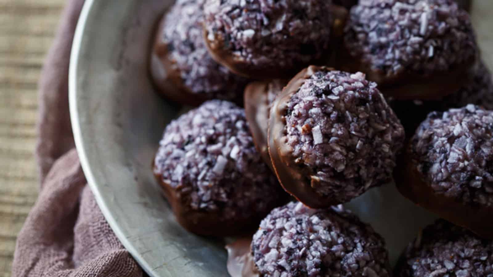 Dark chocolate blueberry macaroons in a metal bowl.