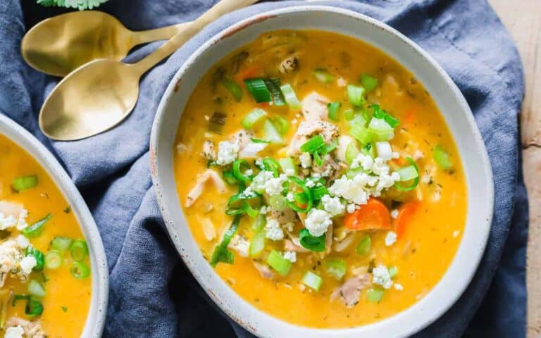 Two bowls of chicken soup on a table.