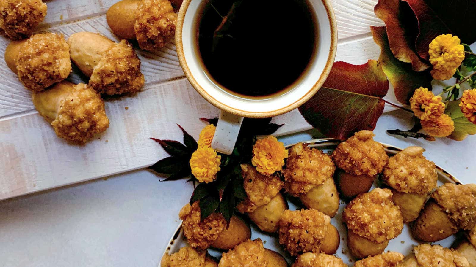 A plate of cookies and a cup of coffee.