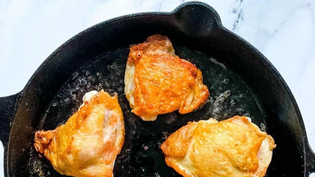 Fried chicken in a cast iron skillet.