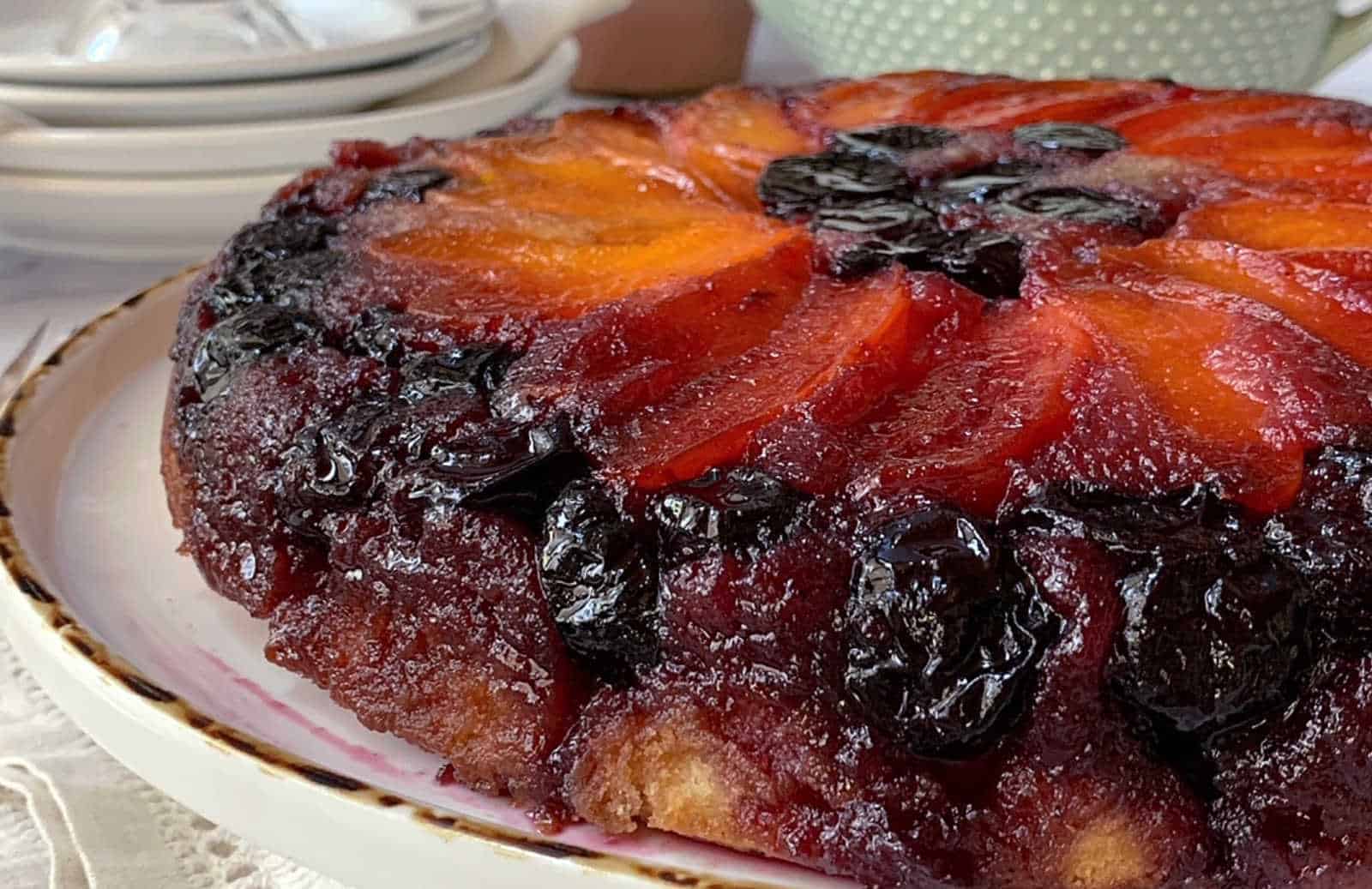 Cherry and apricot upside down cake on a white plate.