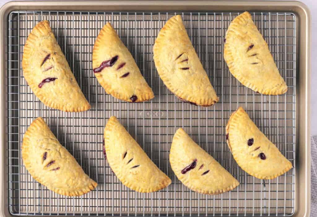 Cherry handpies on a cooling rack.