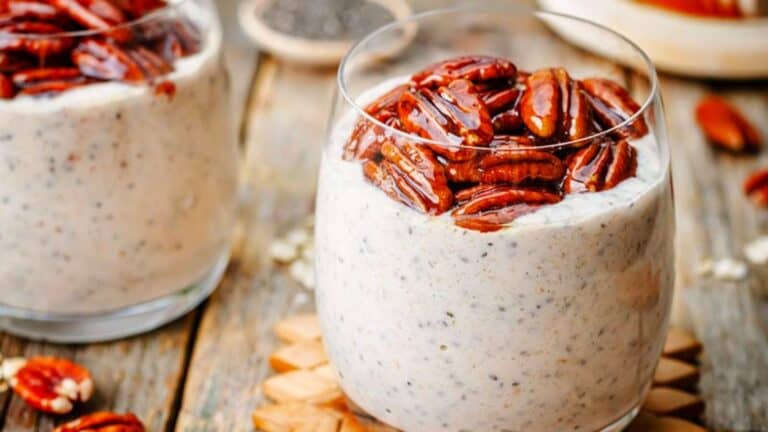 Two glasses of pudding with pecans and chia seeds.