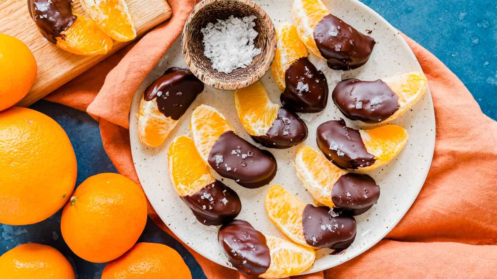 Chocolate covered orange slices on a plate.