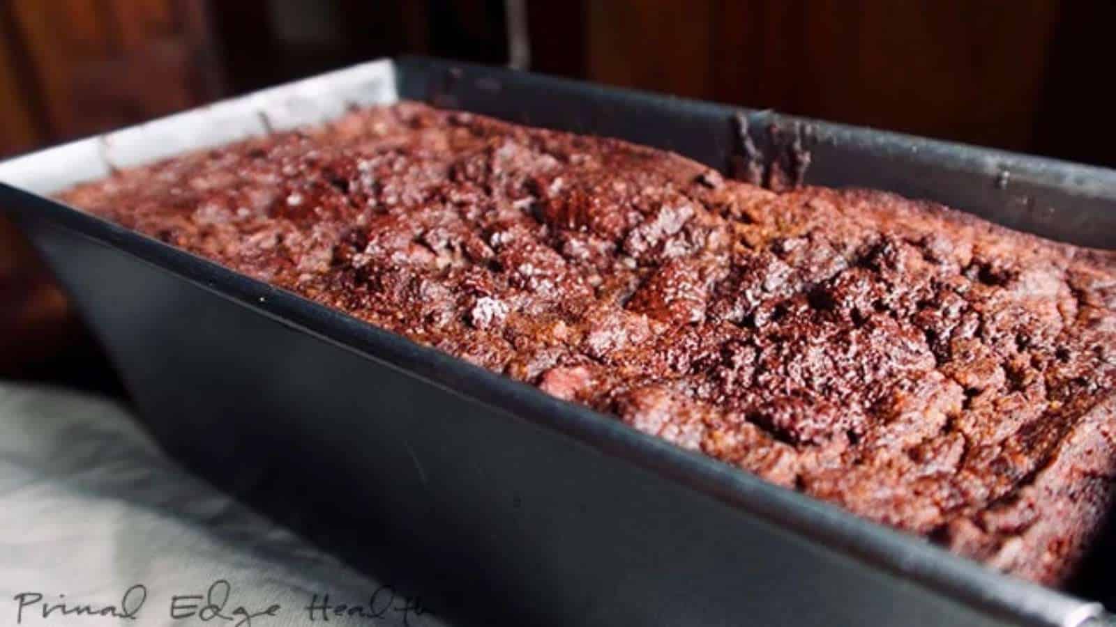 A loaf of chocolate pumpkin bread in a metal baking pan.