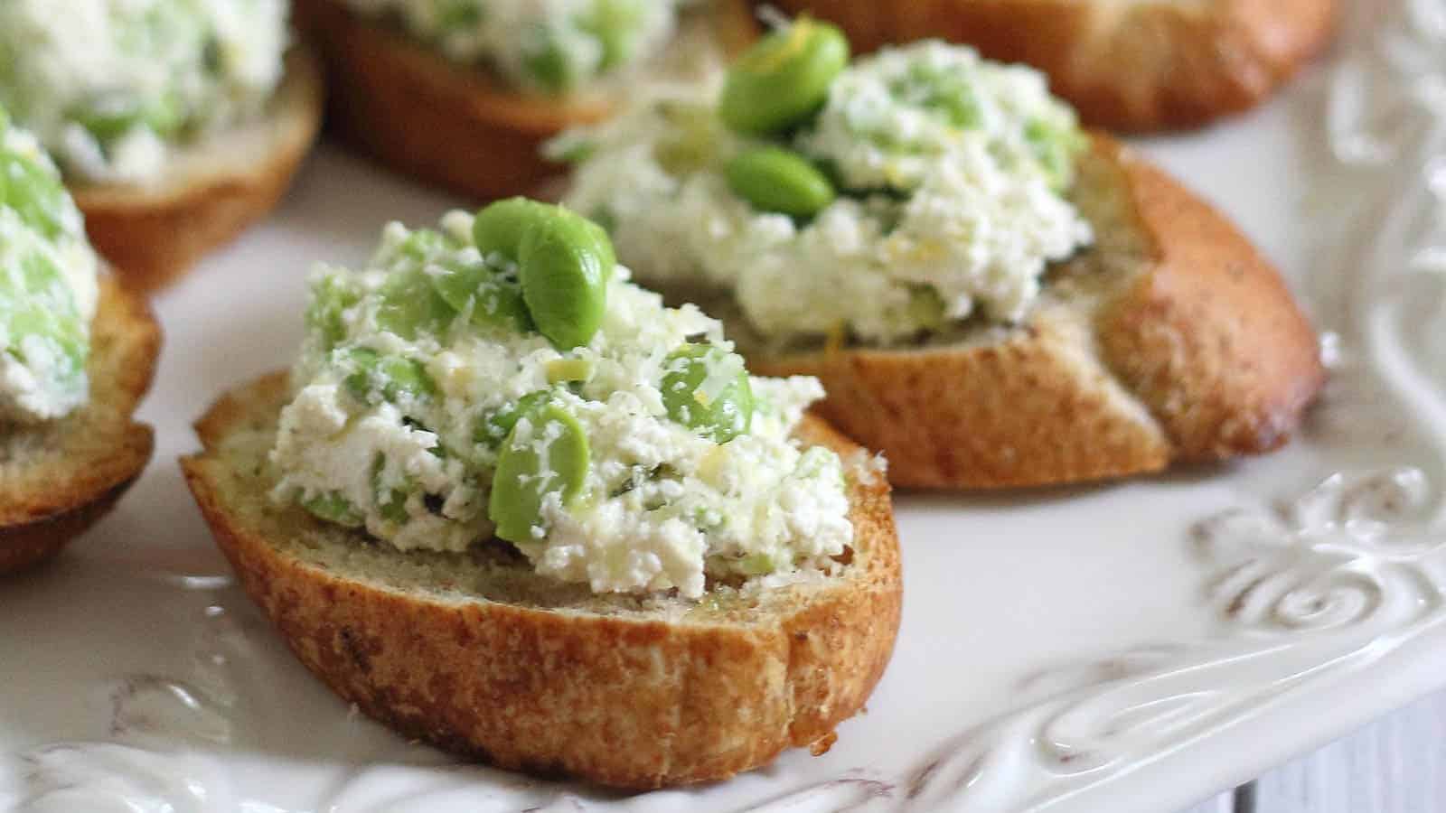 Crostini with cheesy edamame spread.