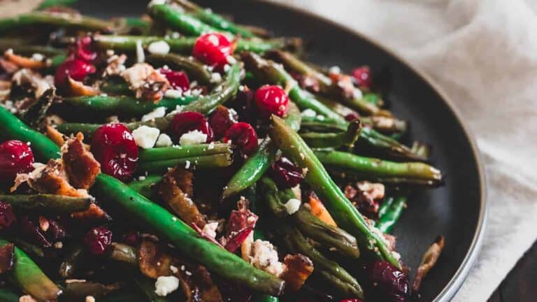 Green beans and cranberries on a plate.