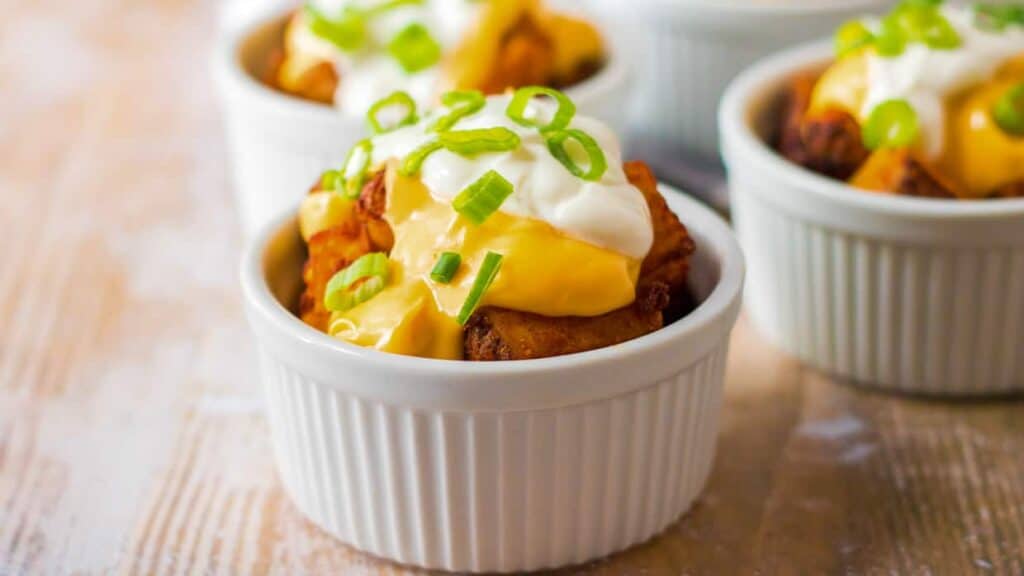 Cheesy potato wedges topped with sour cream and green onions.