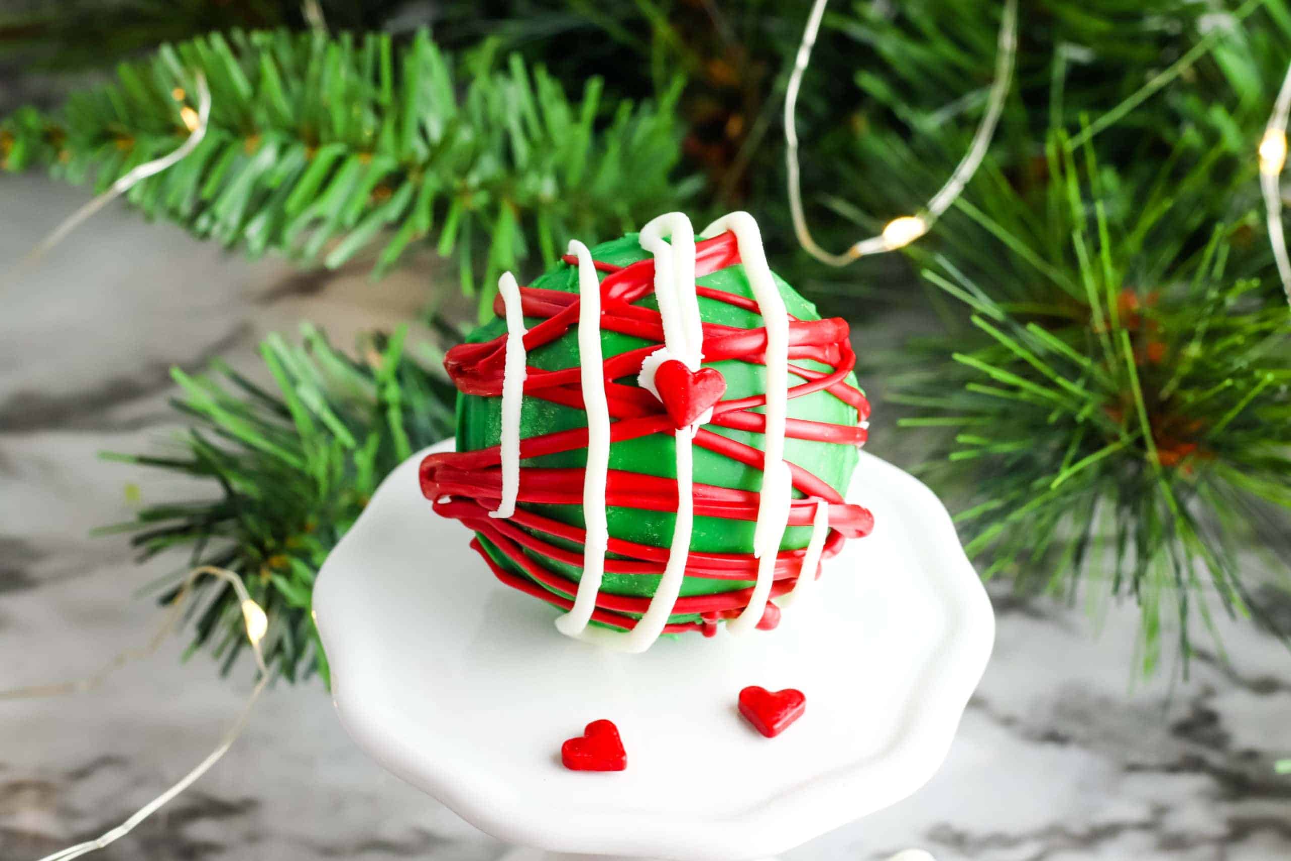 Grinch hot chocolate bomb on a stand.