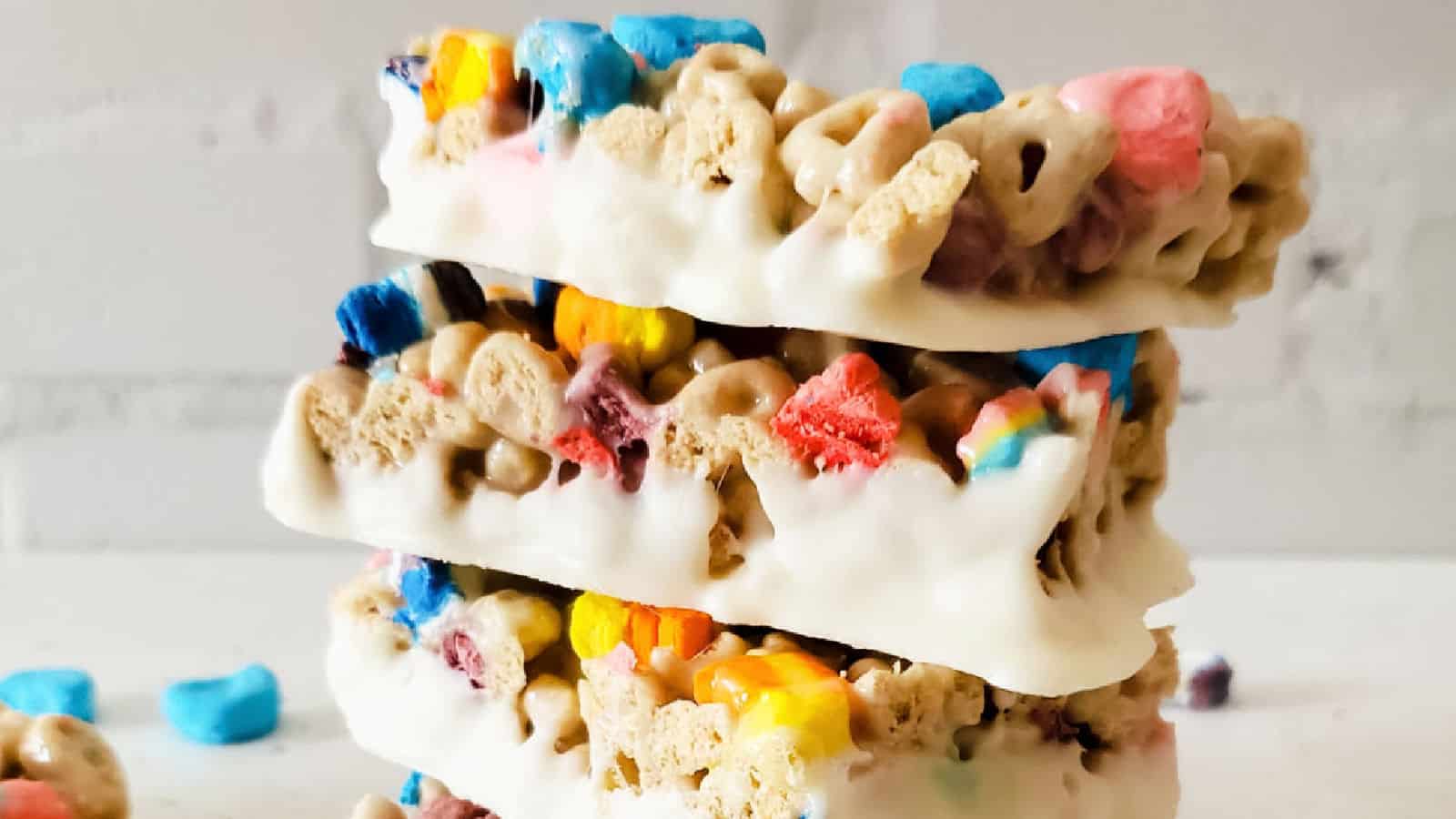 White chocolate dipped Lucky Charms Bars stacked.